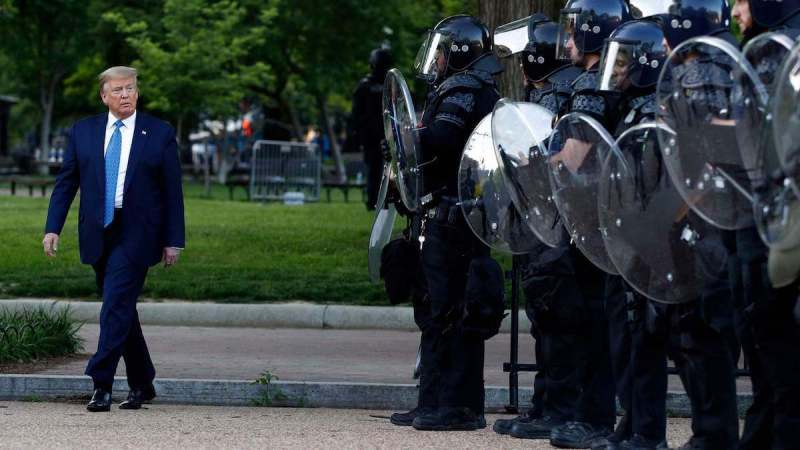 President Donald Trump walks past police in Lafayette Park after he visited outside St. John's Church across from the White House Monday, June 1, 2020, in Washington. Part of the church was set on fire during protests on Sunday night. (AP Photo/Patrick Semansky) (Copyright 2020 The Associated Press. All rights reserved.)