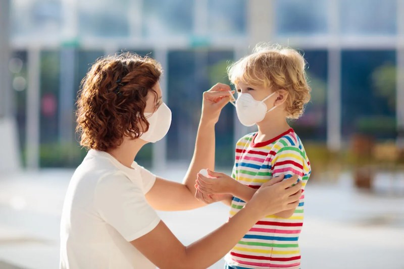 Mother and child wearing face masks while shopping