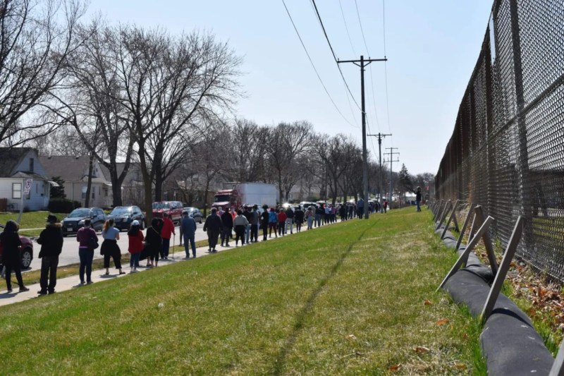 Voters wait in long lines outside one of Milwaukee's five polling places on Apr. 7, 2020.