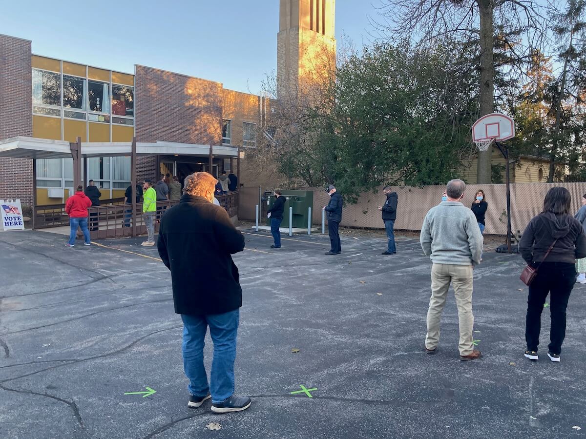 Outside the Emmanuel United Methodist Church in Appleton, the line of social-distanced voters winds around the parking lot at 4 p.m. on Election Day.