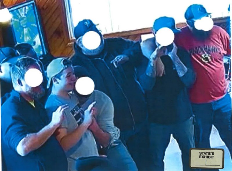 Kyle Rittenhouse holding up a "white power" hand signal.