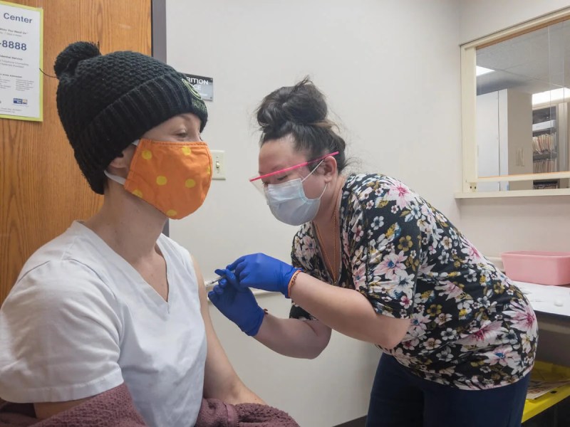 Medical assistant Jeanne Xiong of N.E.W. Community Clinic of Green Bay gives nurse practitioner Michelle Fowles Ceva her second dose of the COVID-19 vaccine on Jan. 27, 2021. (Photo by Christina Lieffring)