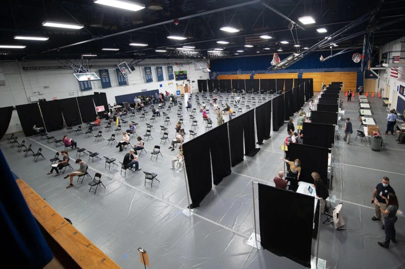People who received vaccinations at UW-Eau Claire’s Zorn Arena, a Federal Emergency Management Agency vaccination site that opened Thursday, sit in a waiting area to make sure they don’t have reactions to the vaccine. The site is one of three FEMA vaccination locations in Wisconsin. (Photo courtesy UW-Eau Claire)
