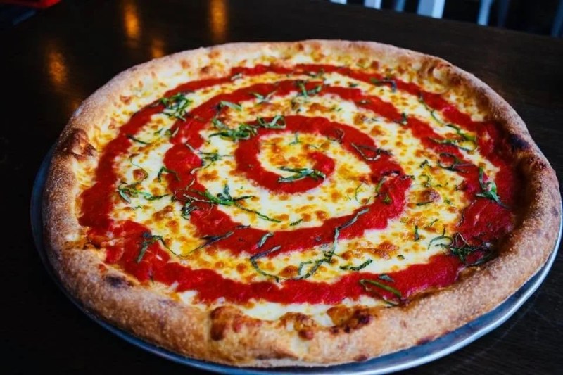 Pizza with tomato sauce swirl at one of Madison's best restaurants