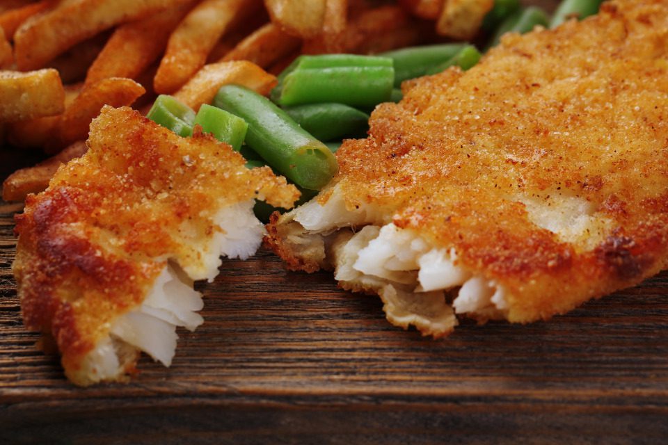 A fried fish filet split in two.