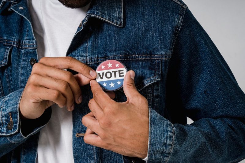 Opinion: Conservatives are trying to change Wisconsin’s constitution to further disenfranchise Black and Brown voters - A Person Wearing a Denim Jacket with Pin Back Button