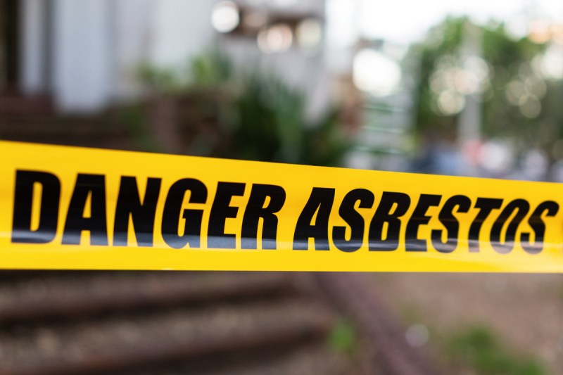 "Danger Asbestos" yellow warning tape barrier