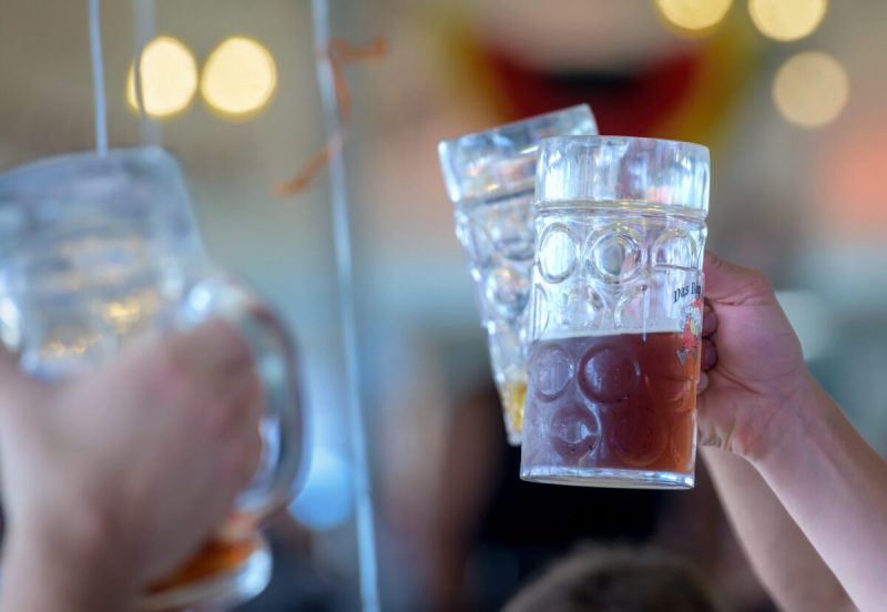 Beer steins are raised during Oktoberfest celebration