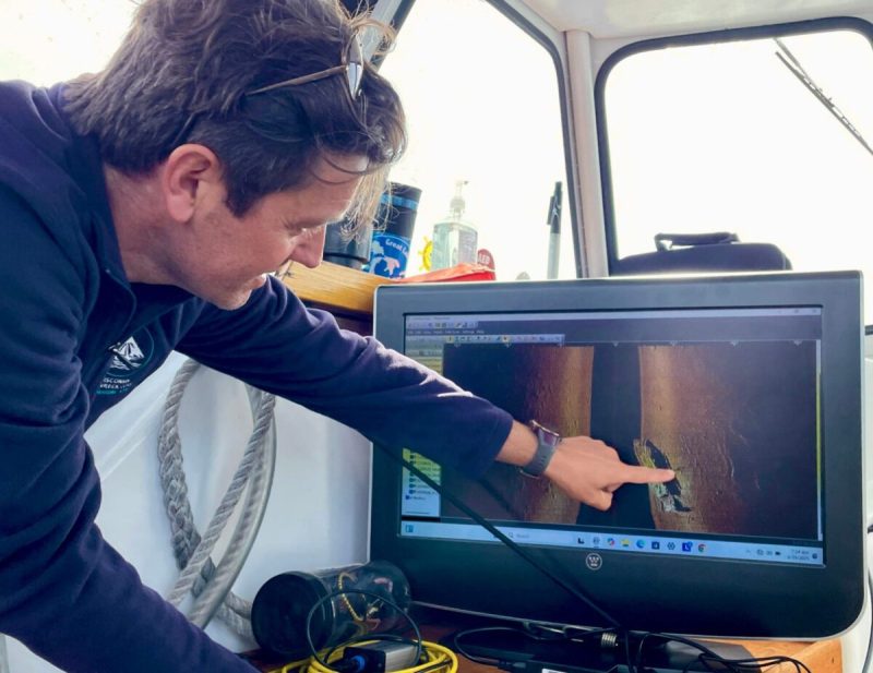 Kevin Cullen, executive director of the Wisconsin Maritime Museum, points to the sonar image of the F.J. King on June 29, 2025. The wooden schooner sank on Sept. 15, 1886 while carrying 600 tons of iron ore from Escanaba, Michigan, to Chicago. The eight man crew survived.