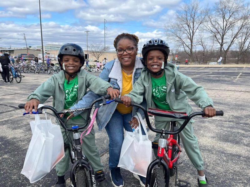 Mom with her twin boys on bikes.
